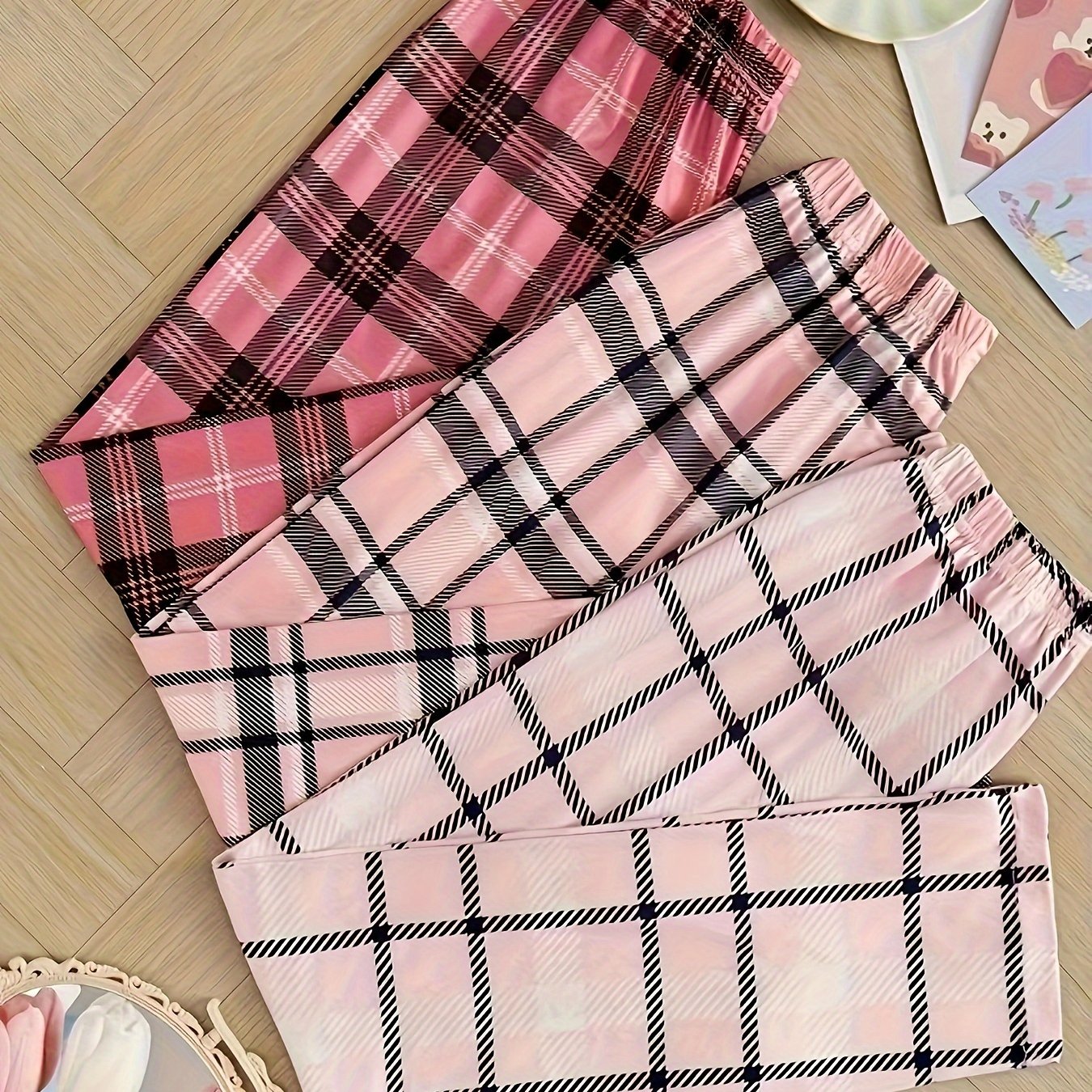 Women's plaid sleepwear pants set in pink and white checkered pattern for summer 2024. Includes elastic waistband for all-season comfort. Machine washable pajama set.