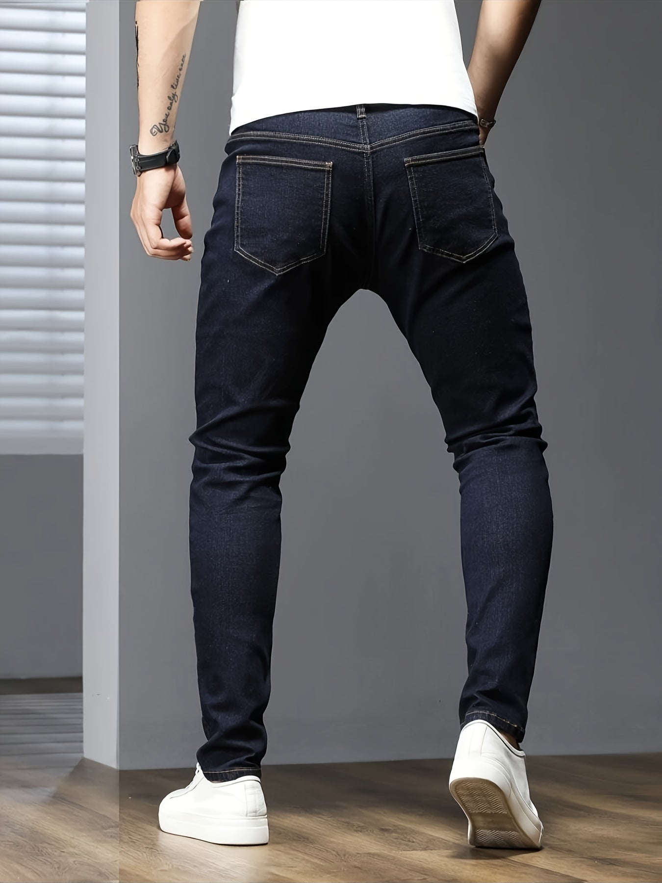 Men's slim fit jeans in solid color, made with stretch denim fabric and raw wash detail, suitable for all seasons.