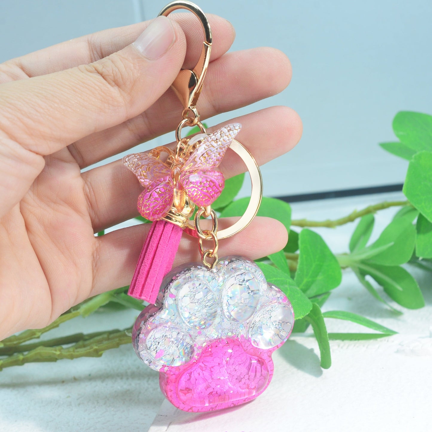 Butterfly tassel ladies bag keychain pendant in the shape of a cat's paw, perfect as a birthday or holiday gift for a creative animal lover.