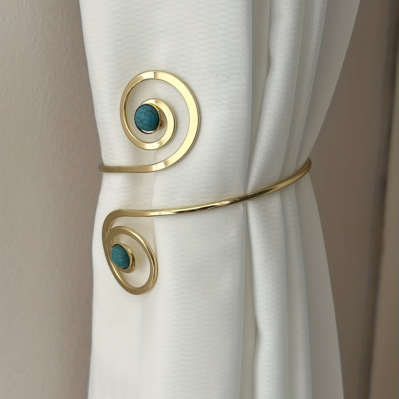 Modern minimalist metal curtain tieback for holding curtains in place, perfect for bedroom or living room decor.