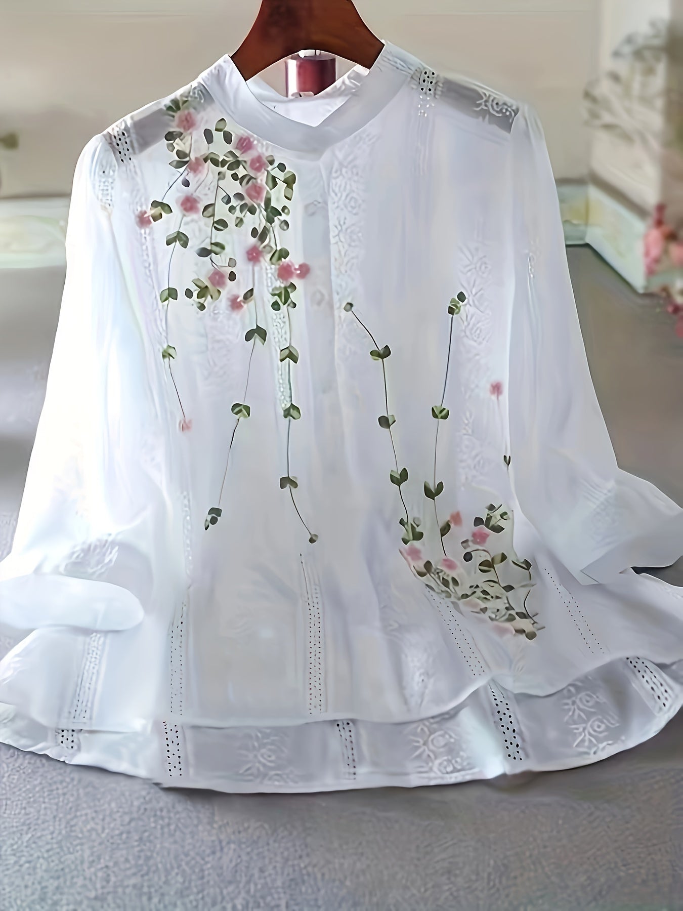 Elegant floral blouse for women, sheer polyester with lace detailing, round neck, perfect for spring/summer. Great for semiformal occasions. Features smocking technique.