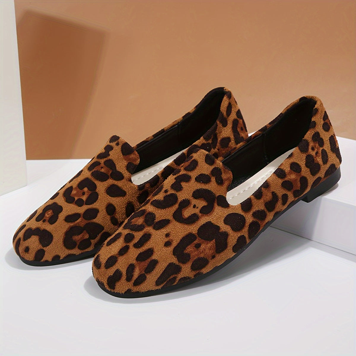 Leopard print women's flats with lightweight slip-on design, plain toe, fabric upper, and plastic sole - perfect for all seasons and versatile boat-style footwear.