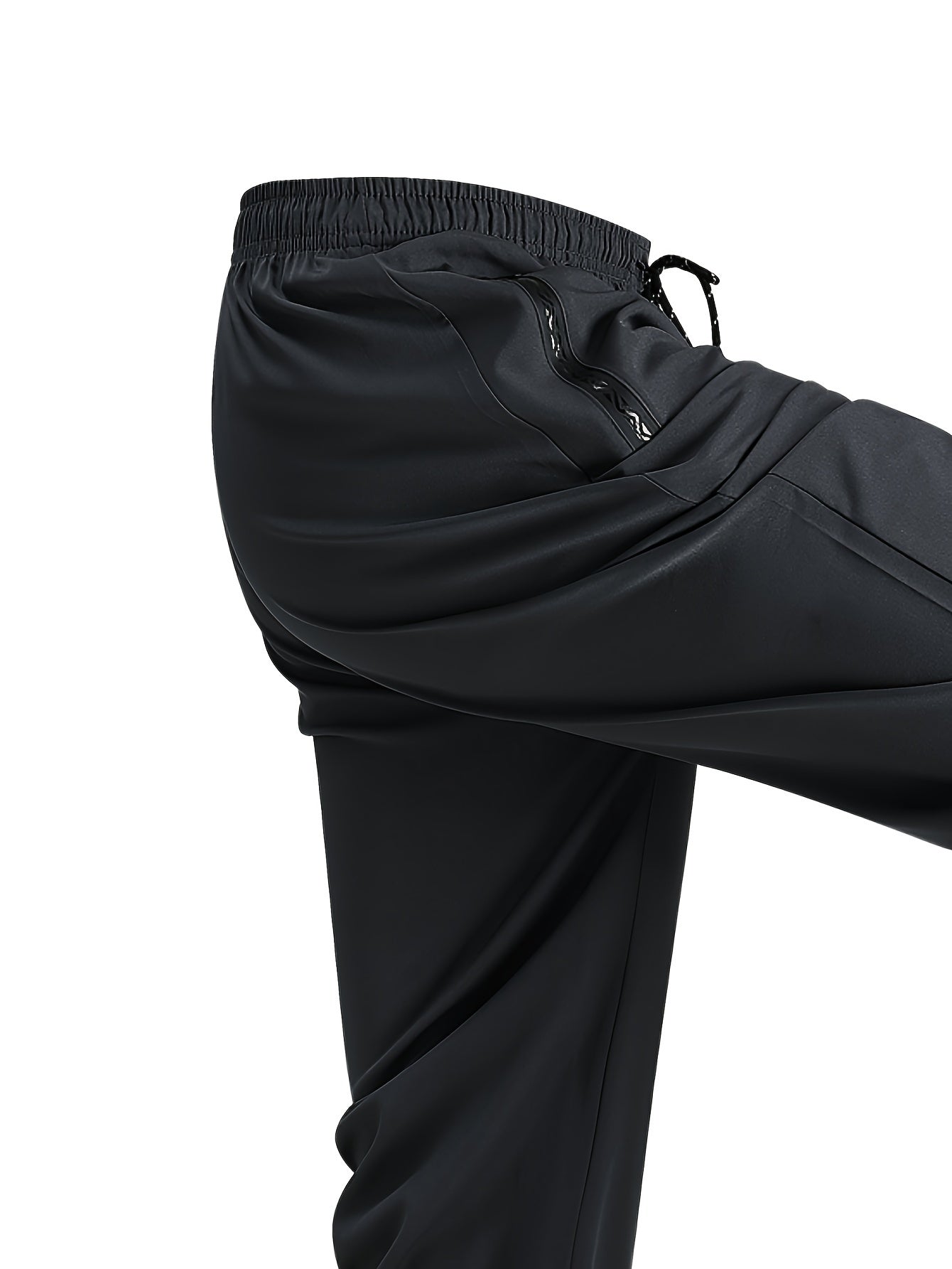 Men's loose-fit polyester pants, breathable and quick-drying, perfect for running and fitness. Features regular length, zipper detail, and printed pattern, ideal for spring and fall.