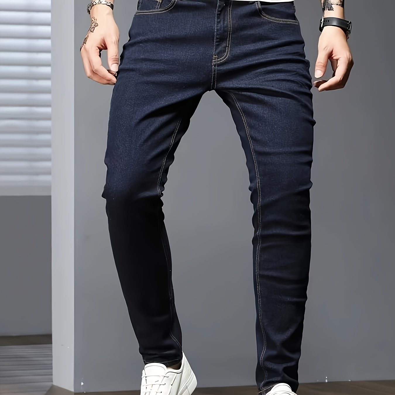 Men's slim fit jeans in solid color, made with stretch denim fabric and raw wash detail, suitable for all seasons.