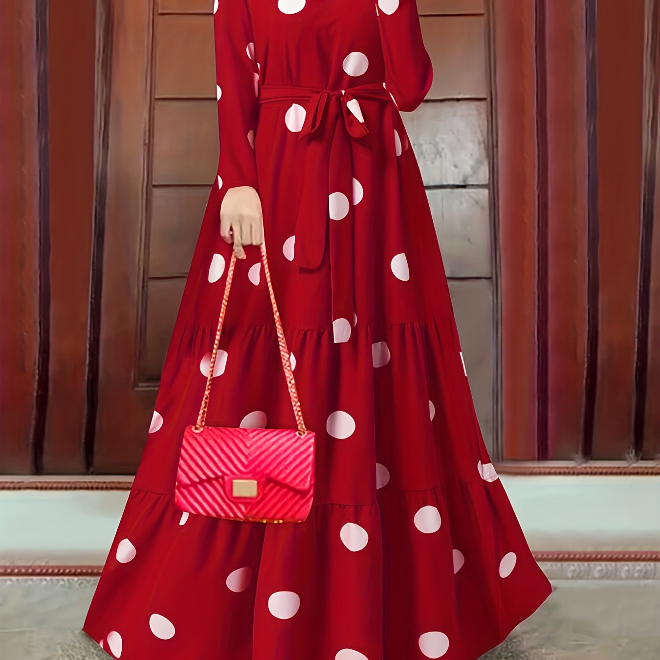 Elegant red polka dot abaya with tie waist, ruffled hem, and long sleeves. Made of 100% polyester, machine washable. Perfect for spring/summer/fall events.