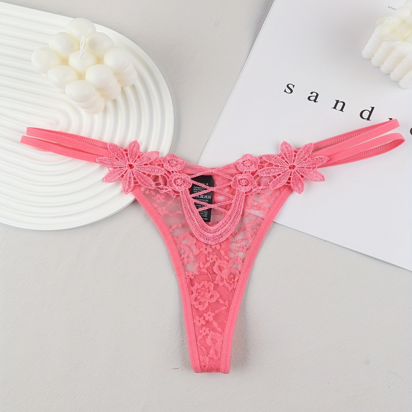 Red lace thong with mesh detail, made of 90% polyamide and 10% elastane, perfect for adults.