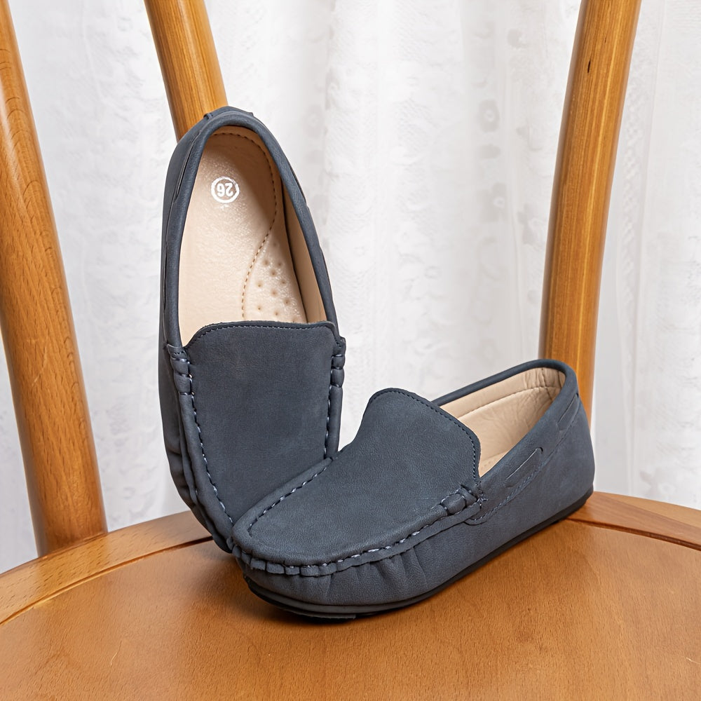 Boys' slip-on loafers in black and brown, suitable for all activities.