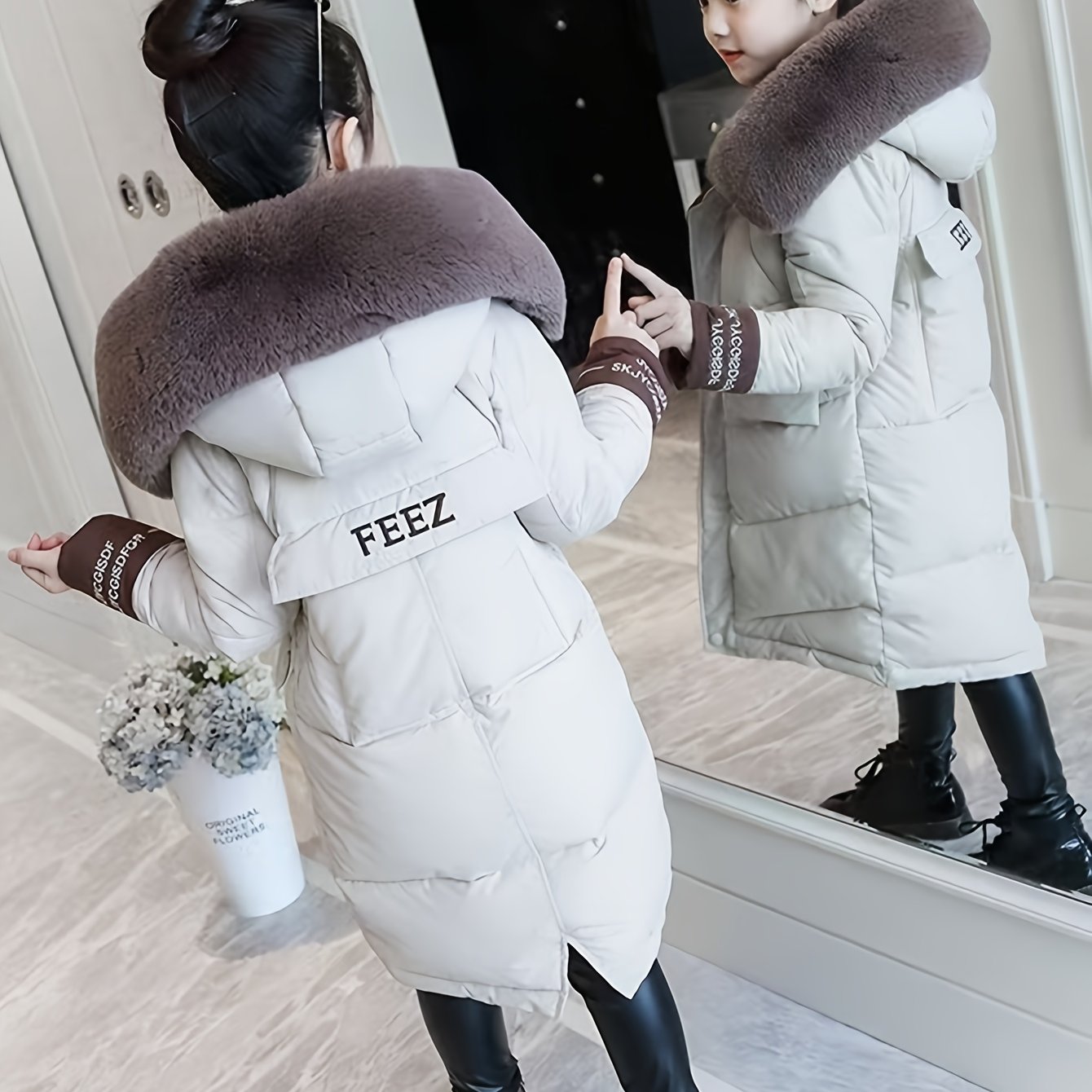 Girls' winter puffer coat with faux fur hood, embroidered alphabet detail, and casual skinny fit. Made of woven polyester, this thick warm jacket is perfect for cold weather.