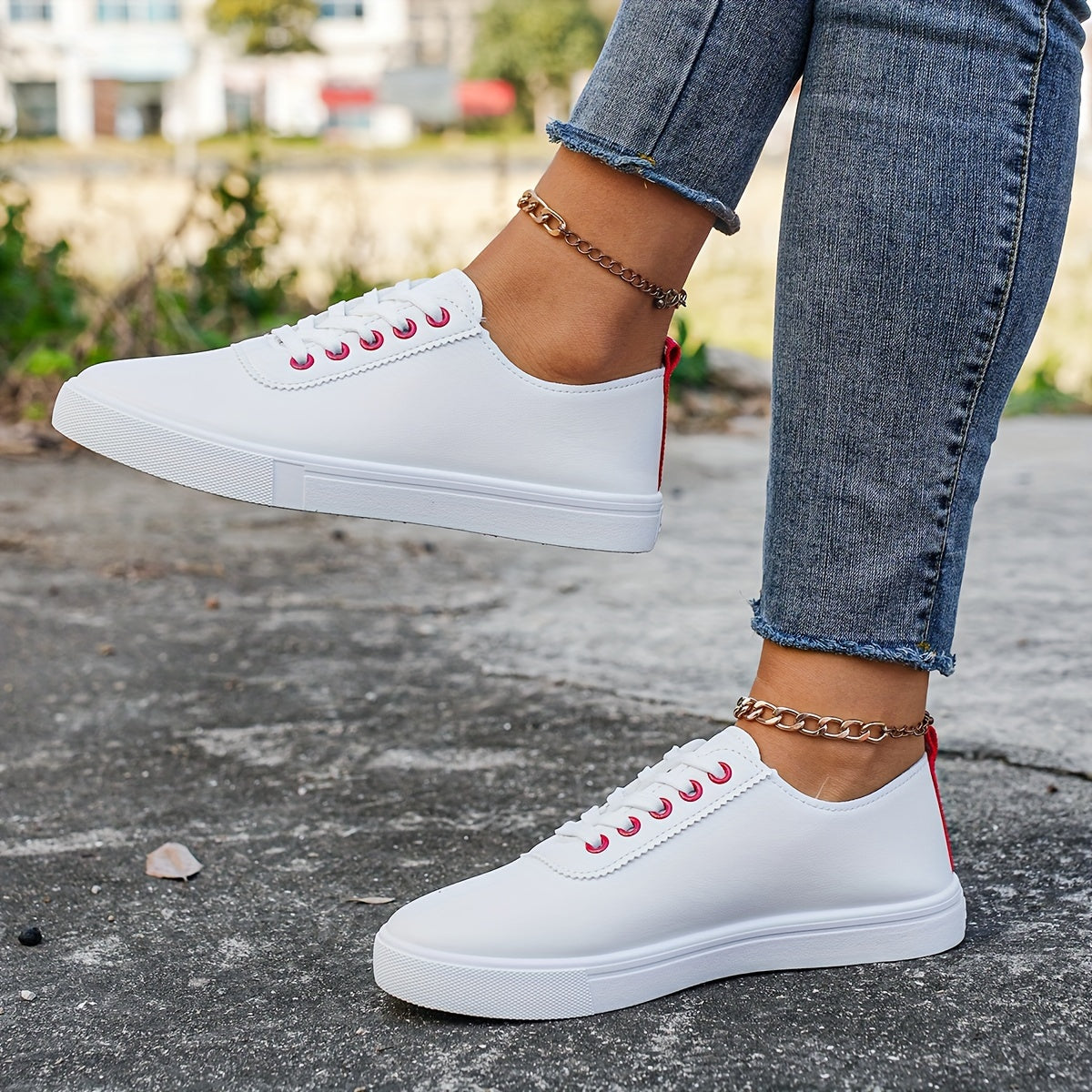 Versatile women's white sneakers with classic design, lace-up closure, round toe, and rubber sole for all seasons. Made with faux leather upper and comfortable fabric lining.