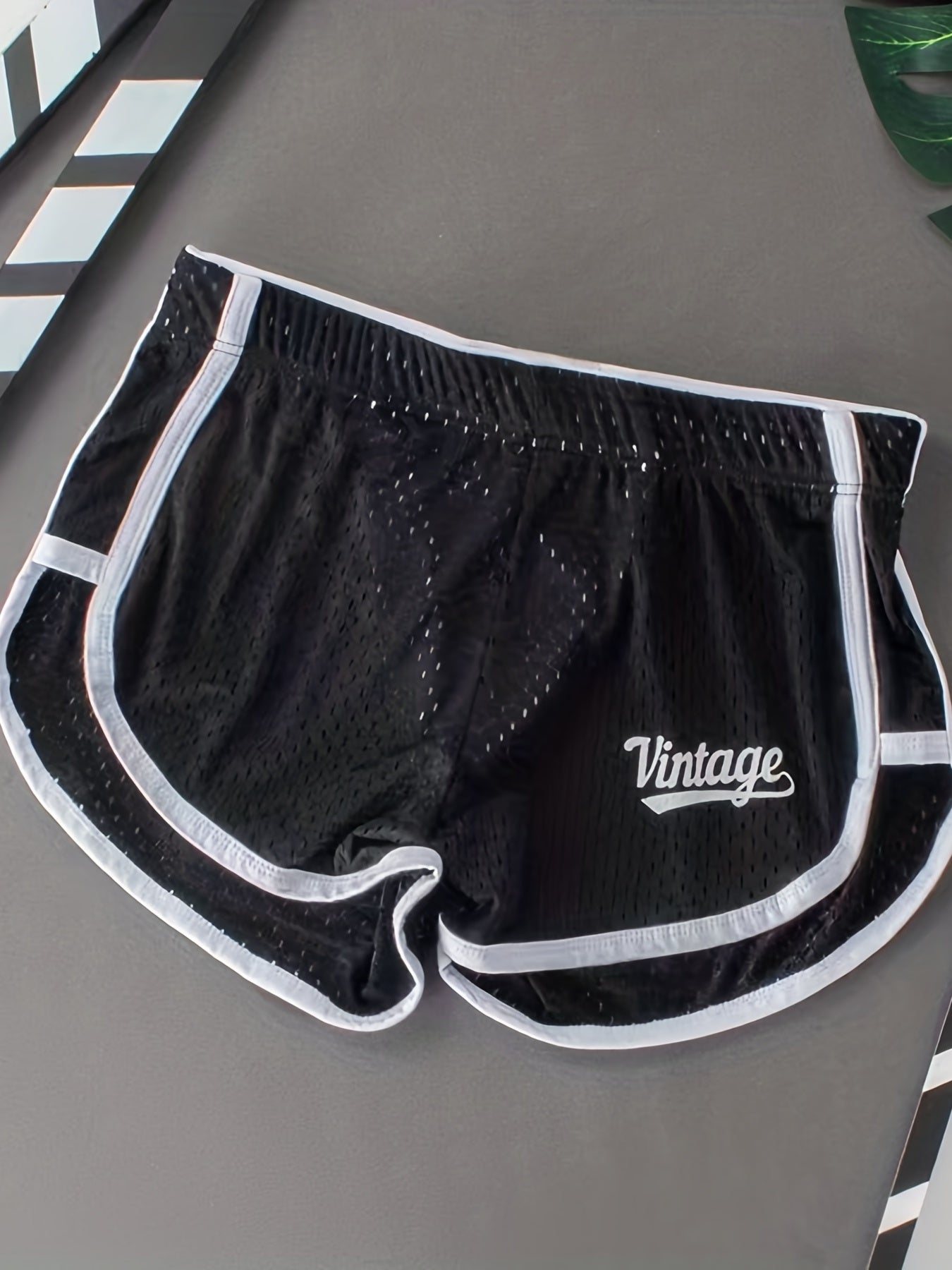 Breathable mesh boxer briefs for men with a comfort fit and contrast trim, suitable for everyday wear and sleepwear.