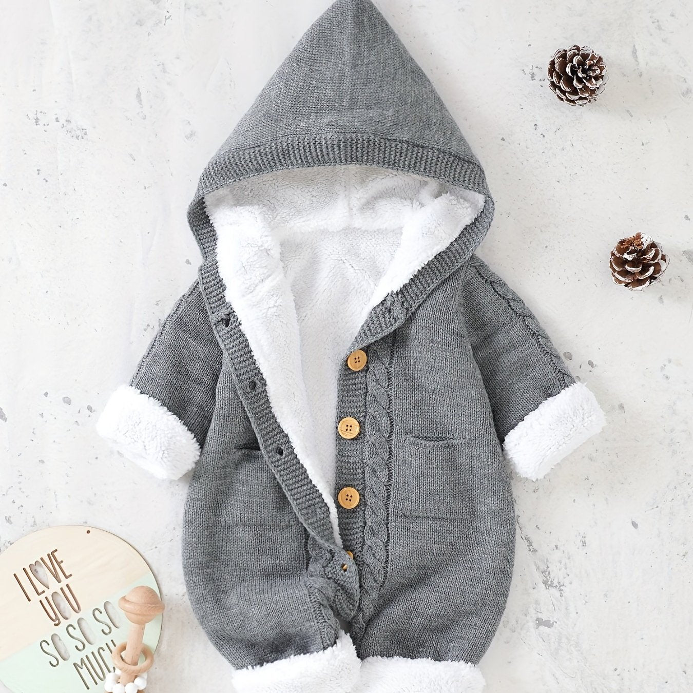 Knitted jumpsuit for newborn boys and girls with long sleeves and hooded pants.