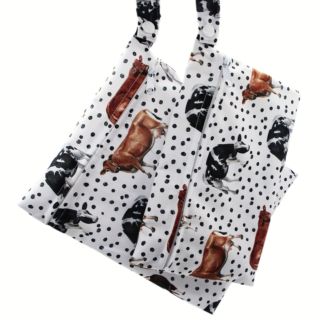 Set of 2 small waterproof wet bags with cow prints.