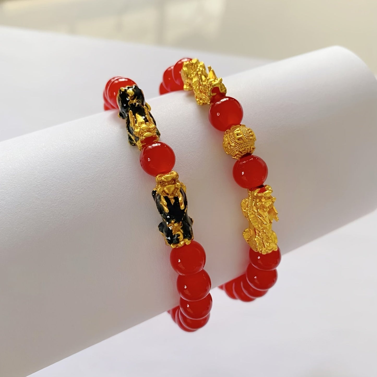 Two Pixiu bracelets, one in red antique style, offering a safe and lucky accessory. This classic, luxurious piece symbolizes prosperity and is beautifully crafted with shiny, artificial jewels. Perfect for gifting to girlfriends, sisters, or mothers to