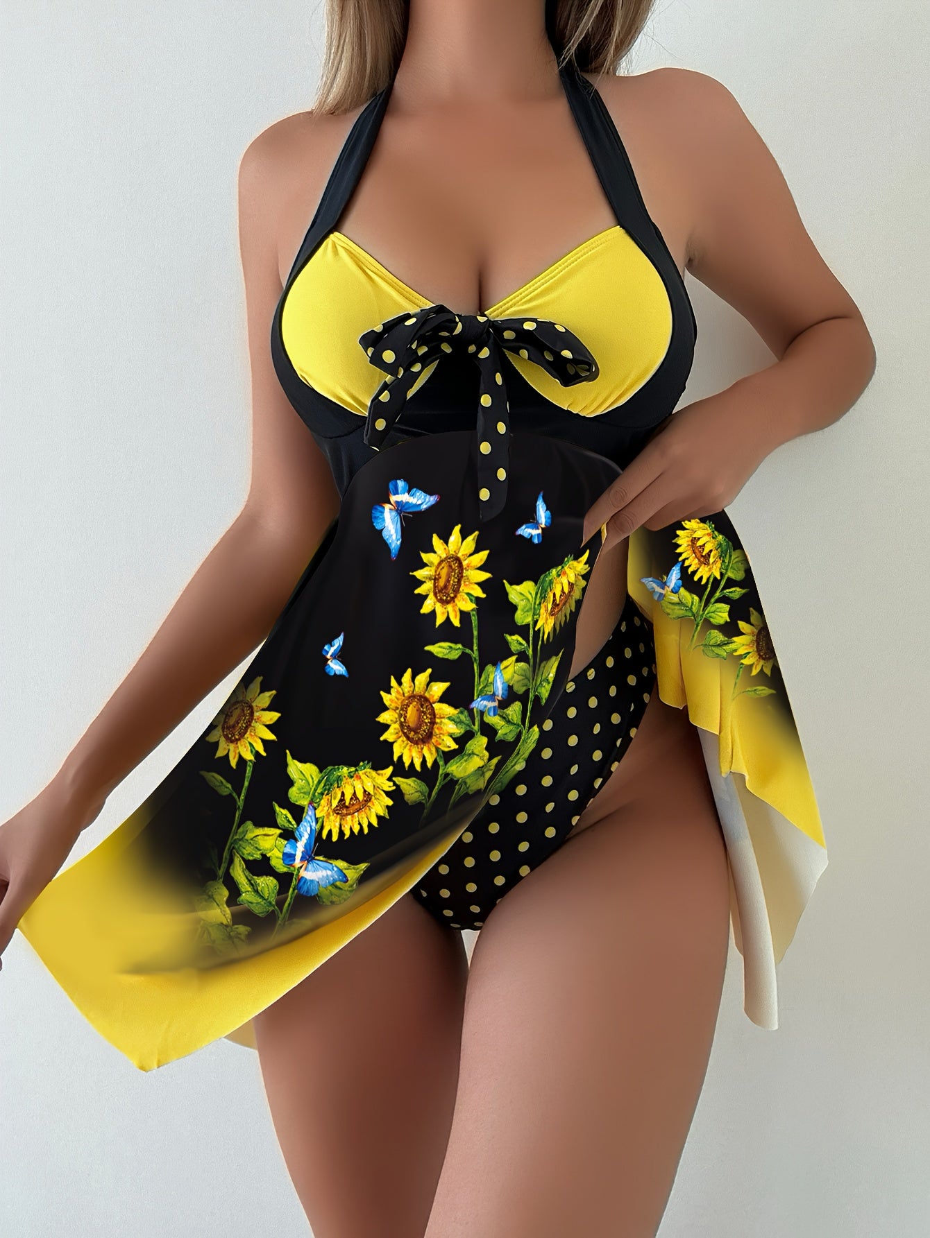 Women's 2 piece tankini set with sunflower print top, bow swim dress, and dot print bottoms.