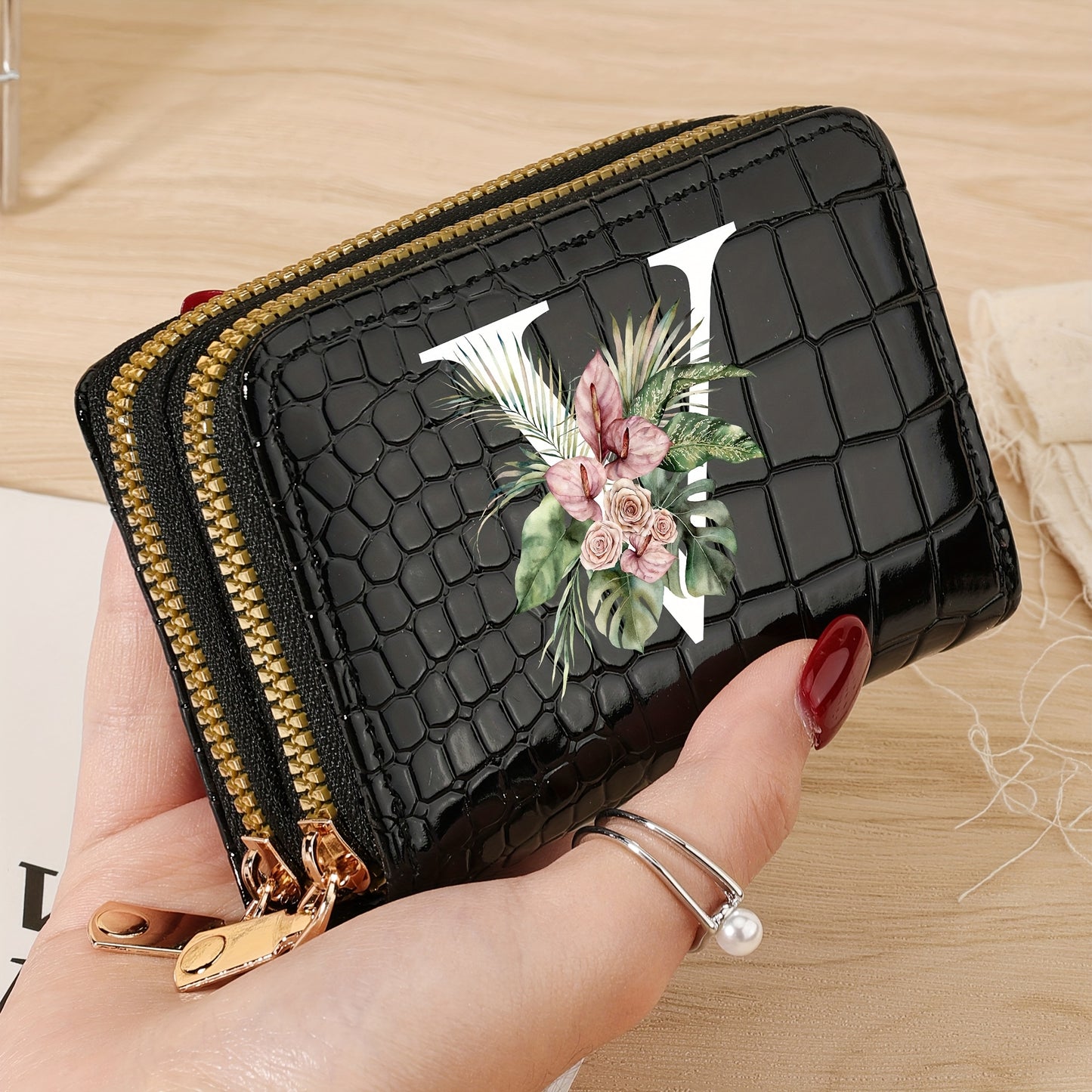 Women's credit card wallet with elegant floral letter print in black & white. Features large capacity, dual zipper, crocodile texture PU, lightweight design with nylon lining for everyday