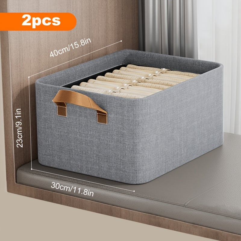 Two folding storage bins featuring metal frames, made of household fabric with handles. These large capacity boxes are perfect for storing clothes or toys in a closet, wardrobe, dorm room, or under the bed, serving as a space-saving organization solution.