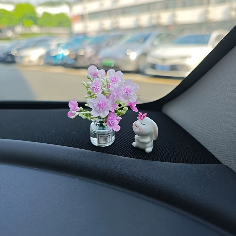 Miniature resin vase for car dashboard décor with healing figurine.