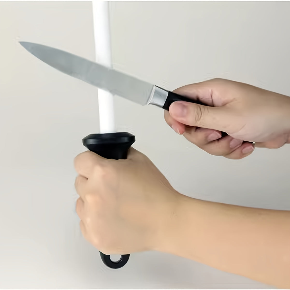 Upgrade your kitchen with a 10-inch ceramic sharpening rod complete with a safety guard and ergonomic grip. Perfect for home cooks, professional chefs, and restaurants alike. This fine grain rod doesn't require any power, making it a convenient and