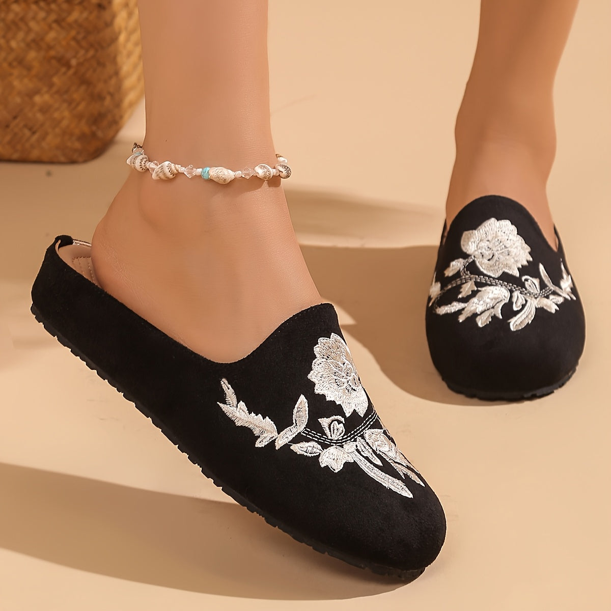 Stylish black embroidered floral mules with soft rubber sole and faux cover lining for comfortable year-round wear.