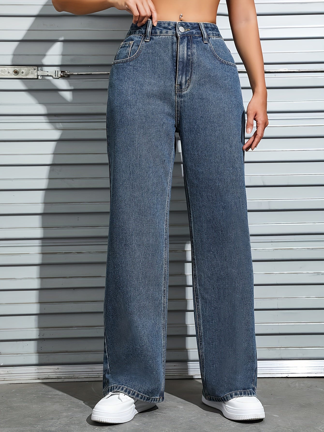 Women's plain washed blue loose fit jeans with slash pockets, perfect for casual autumn wear.