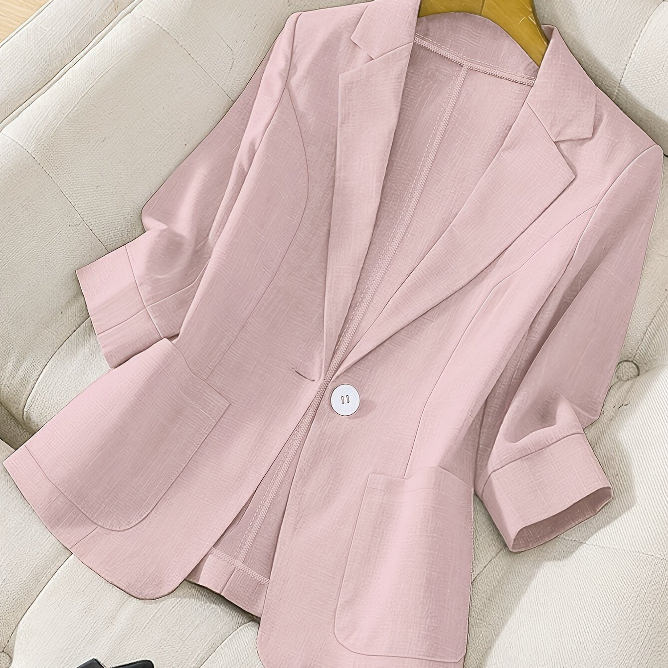 Chic light blue women's blazer with pockets, long sleeves, and notched collar. Made of machine-washable polyester, ideal for spring and summer office casual attire.