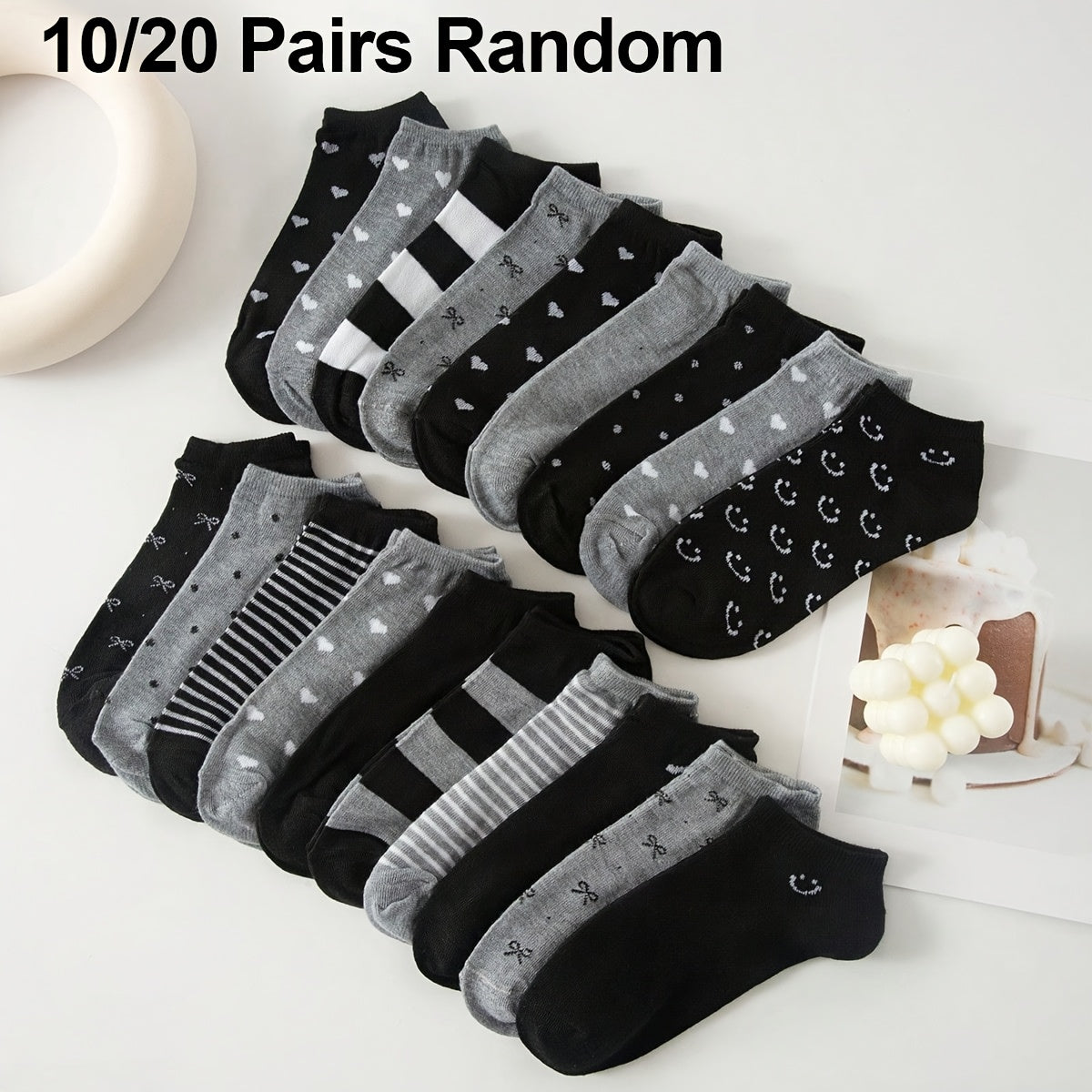 Women's ankle socks in black and grey with assorted geometric patterns. Made from comfortable knit fabric, 95% polyester and 5% spandex. Random style shipping. 10/20 pairs available.