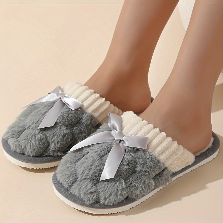 Winter plush cozy non-slip shoes with soft sole and flat bowknot decoration, ideal for home warmth.