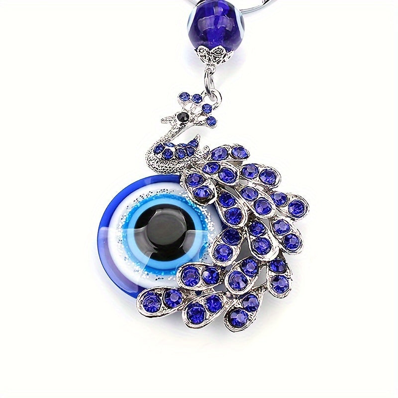 Blue Evil Eye Keychain with Rhinestone Inlaid Peacock Design, made from Alloy, Perfect for Women's Daily Use as a Trendy Hanging Pendant or Bag Charm.