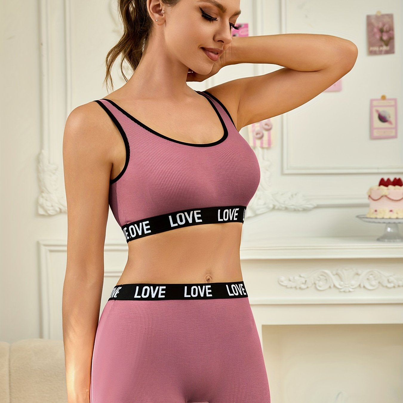 Letter waistband bra set includes breathable seamless sports bra and high-waisted shorts made of viscose and elastane fabric.