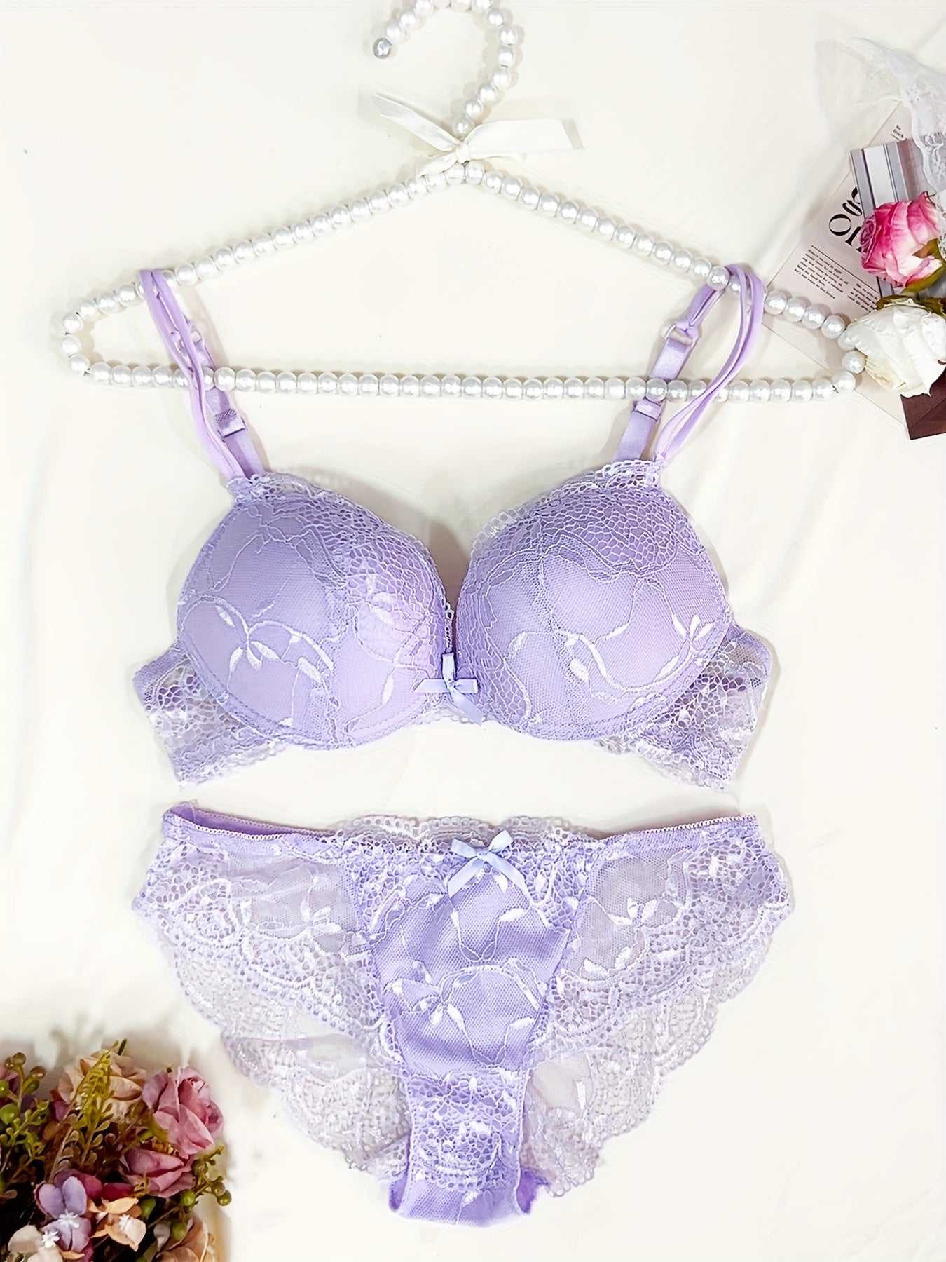 Medium support lace bra and panty set with contrast lace detail, made of 85% polyamide, 7% polyester, 5% elastane, and 3% viscose. Features drop waist briefs and chest pad.