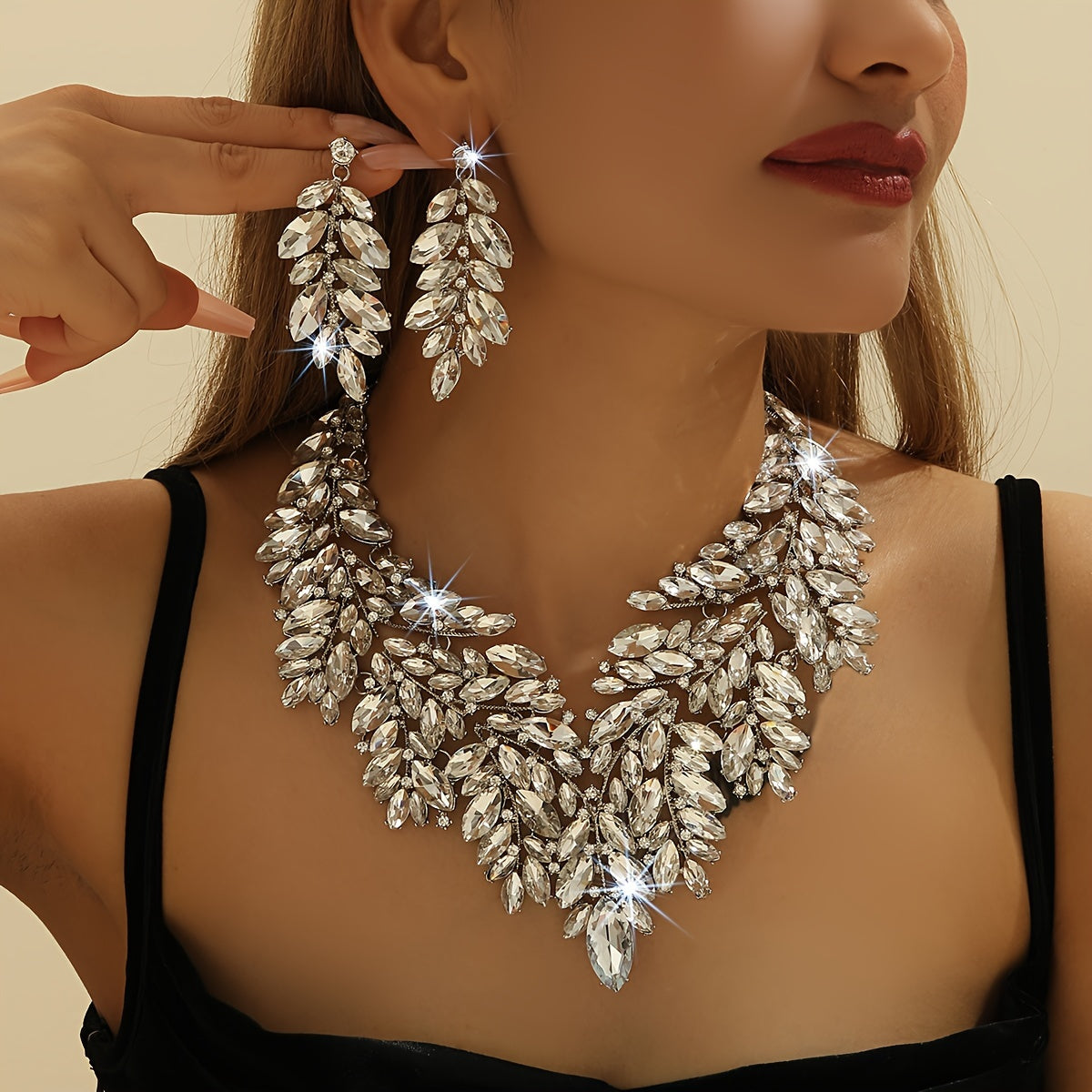 Luxurious wedding jewelry set crafted with fine materials and adorned with shimmering artificial crystals. This exquisite 3-piece set includes a necklace and earrings, perfect for weddings and special events. A timeless gift for any occasion, making it