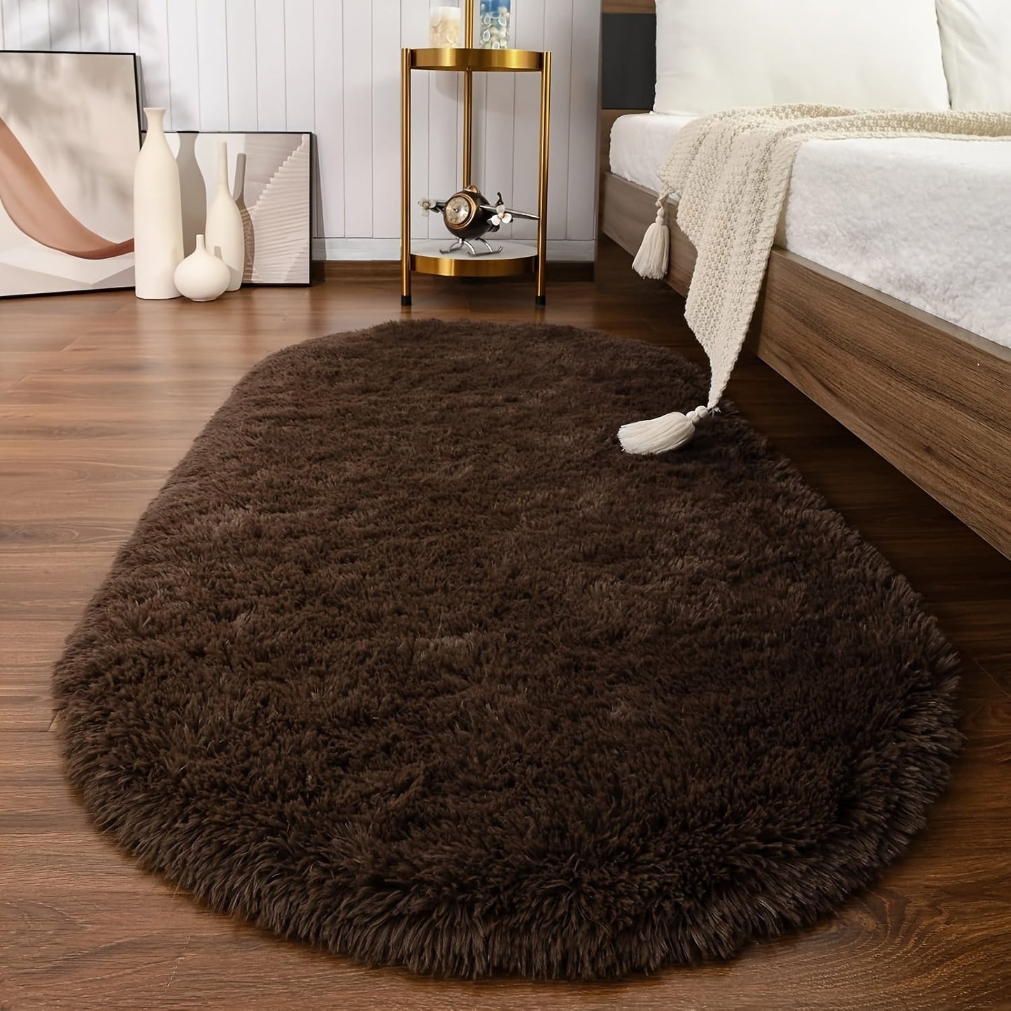 Soft and fluffy oval shaggy area rug, perfect for bedroom or living room. Made with skin-friendly thickened sponge and tufted polyester material. Durable and easy to maintain. Adds decorative touch to indoor spaces such as sofa, bedside, playroom, or