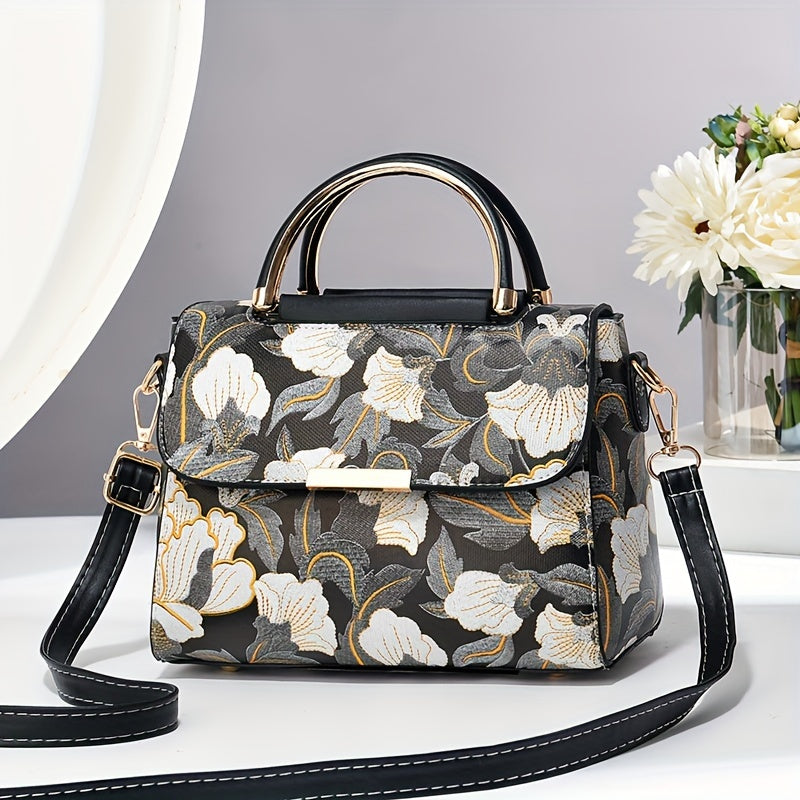 Large capacity floral embroidered crossbody bag with zipper closure and polyester lining. Versatile commuter handbag with luxurious, fashionable design and edge paint detail. Available in