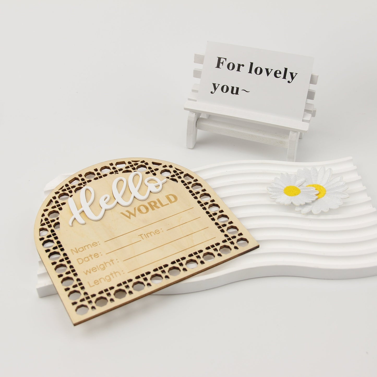 Wooden birth announcement plaque in fan-shaped design, featuring "Hello World" message. Perfect for photo props, this engraved keepsake plaque measures 13.97cm and includes fields for birth details. In a beautiful apricot color, this plaque is suitable