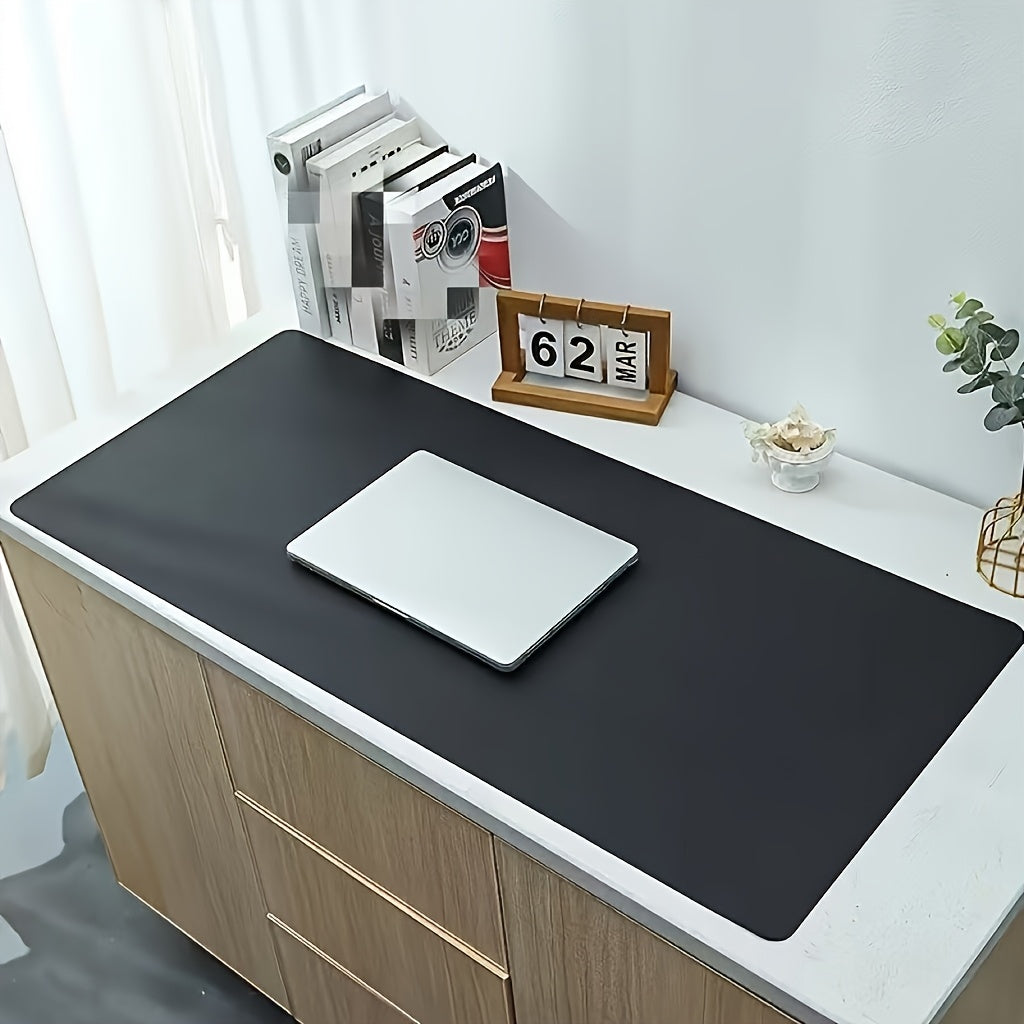 Black non-slip desk mat for office, ideal for computer and mouse.