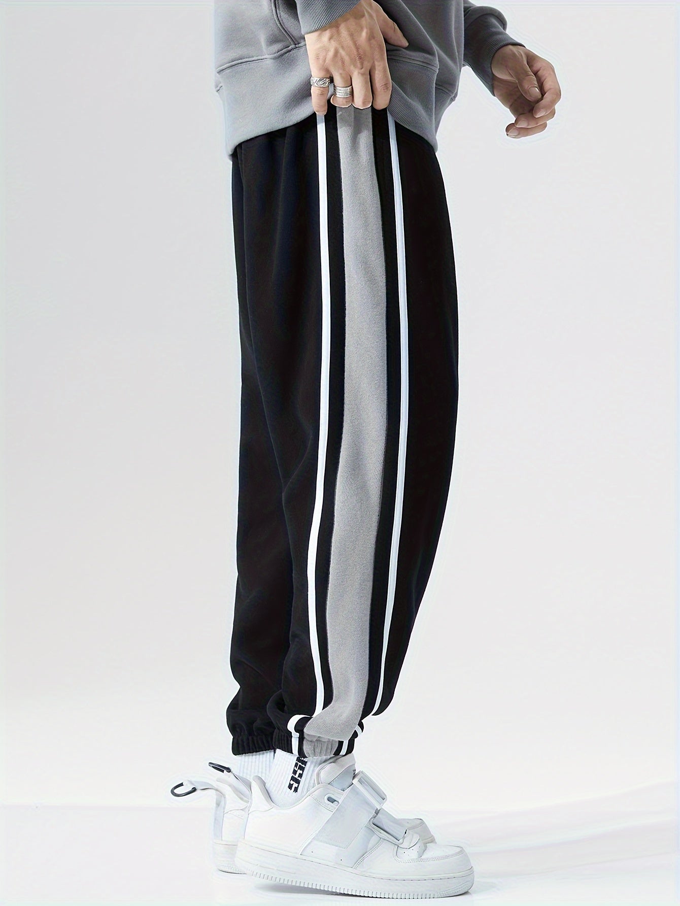 Men's loose sports pants for summer and fall, trendy style, available in large sizes, suitable for casual wear.