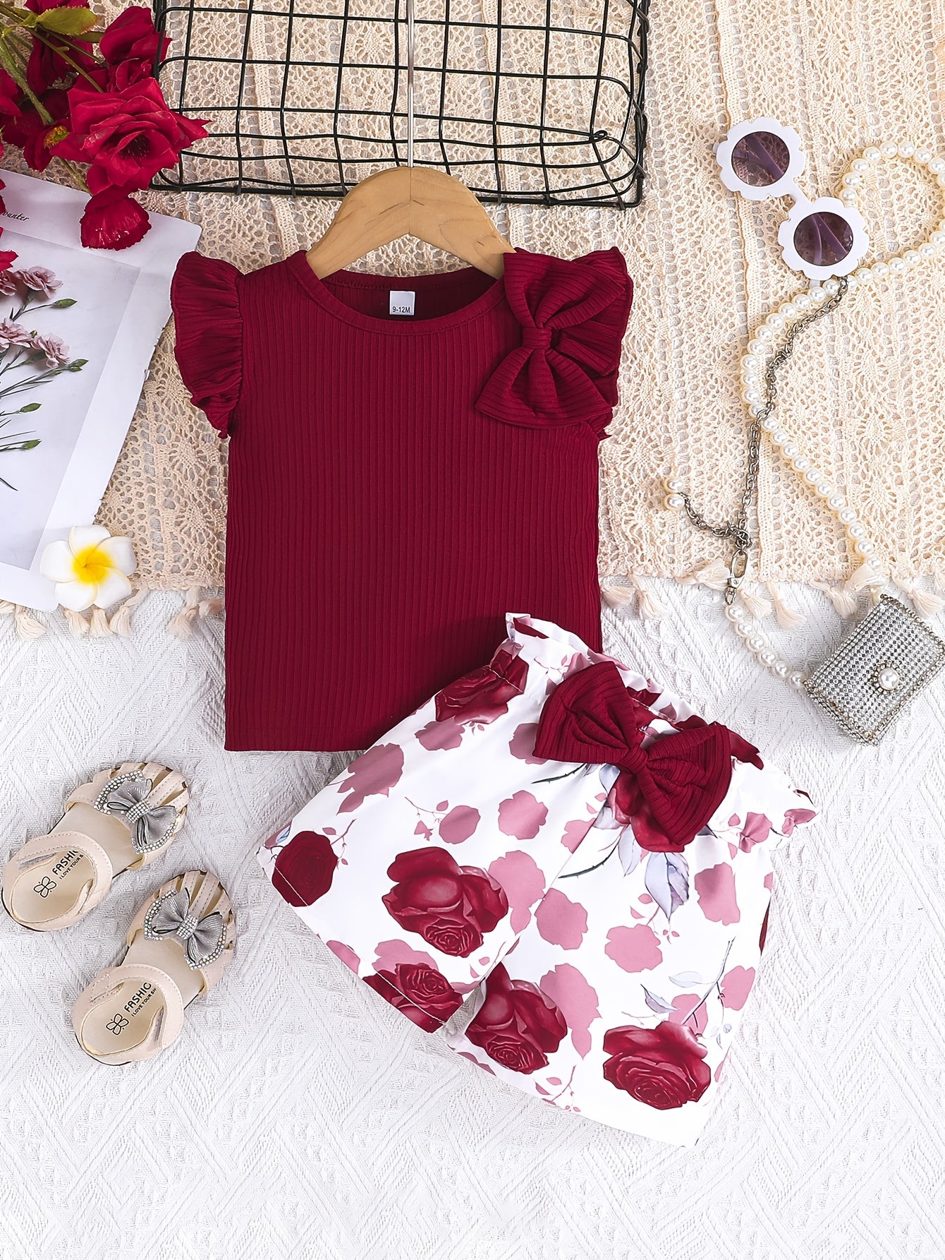 Cute girls' summer outfit: Maroon ribbed T-shirt with bow and floral print shorts set - Made with easy-care polyester blend, machine washable, ideal for outdoor wear.