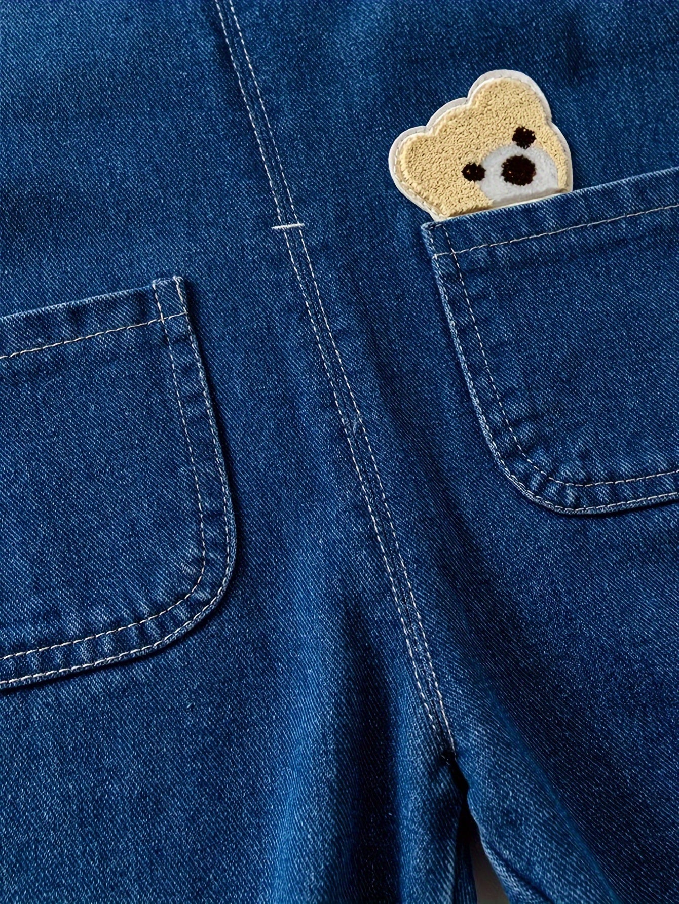 Children's denim overalls with animal pocket detail, made from a cotton blend fabric. Ideal for spring and fall seasons, this unisex toddler jeans romper is perfect for outdoor play.