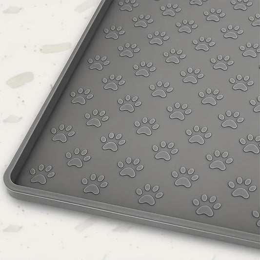 Gray pet feeding mat with paw print design, prevents spills and mess, ideal for cats and dogs.