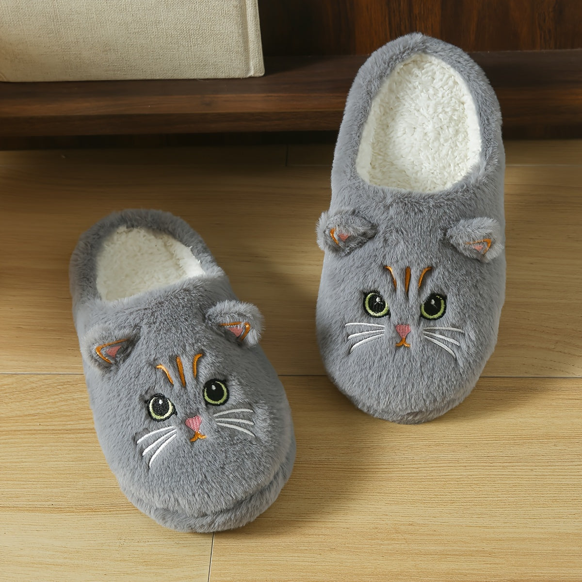 Cozy cartoon cat eyes winter plush slippers with soft sole, fluffy material, and hand washable. Perfect for cold weather and comfort. Ideal for indoor use.