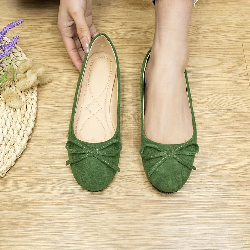 Women's bowknot flat shoes in solid color suedette, slip-on style with soft sole.