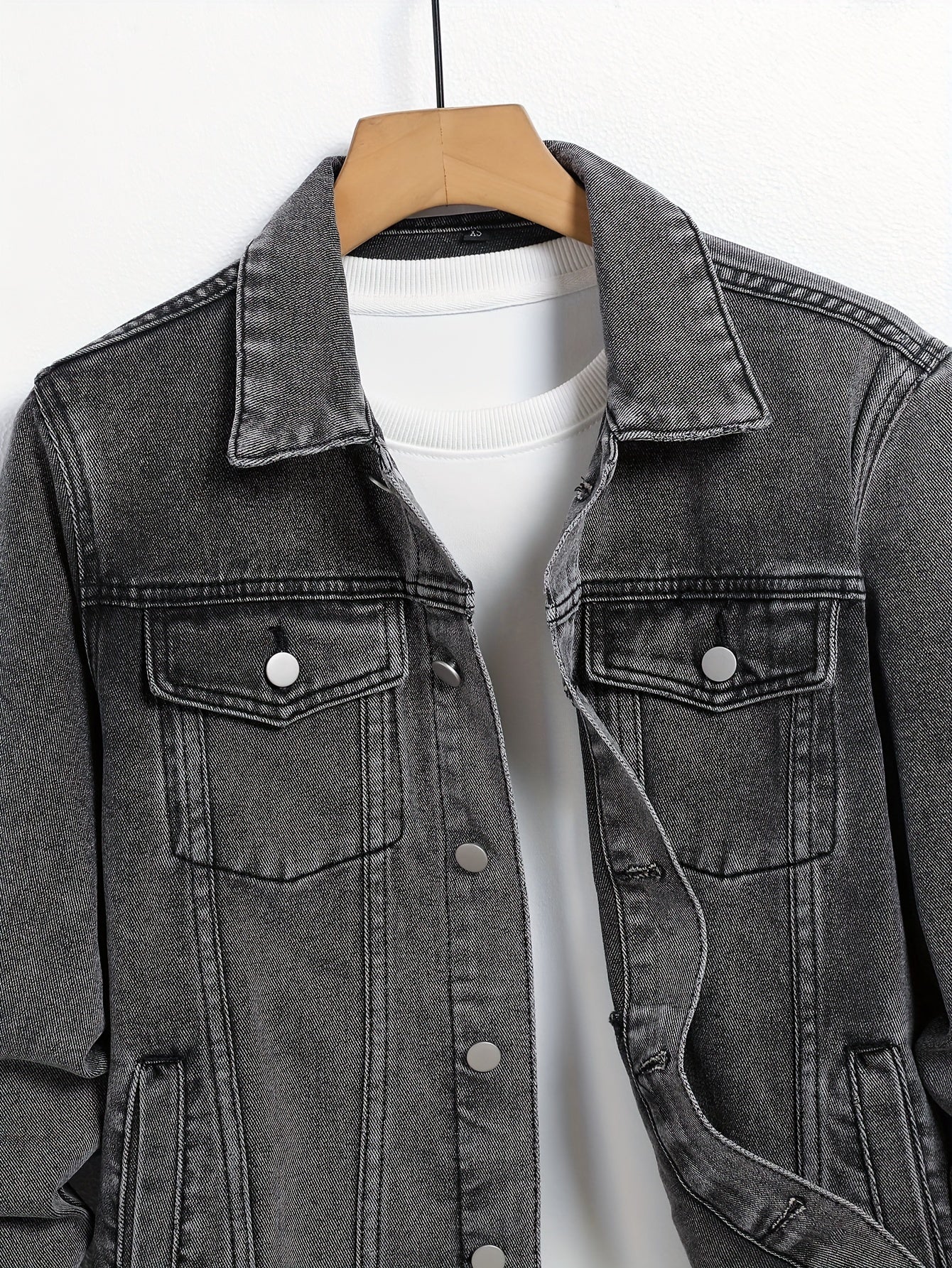 Plus size men's casual denim jacket in solid color made from a cotton blend with lapel collar, utility pockets, and regular fit.