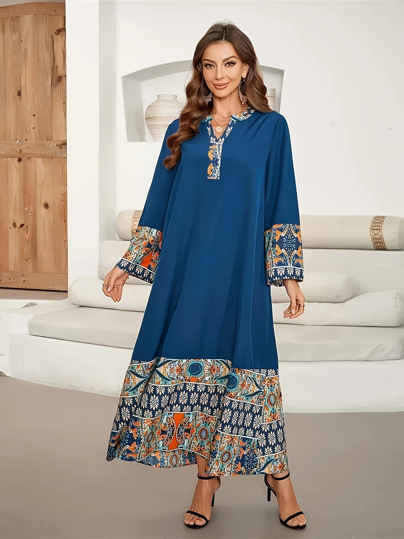 Elegant two-tone Muslim Abaya dress with paisley and floral design, blue long sleeves, polyester fabric, asymmetrical hem, and includes hijab. Ideal for all seasons.