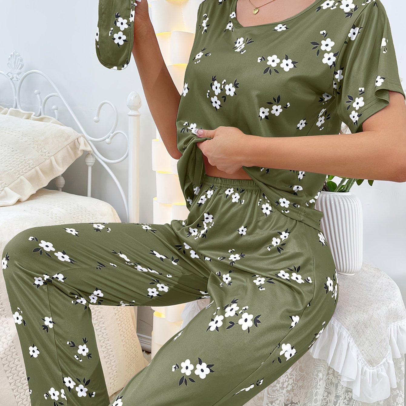 Women's floral pajama set with short sleeve top and elastic waistband pants.