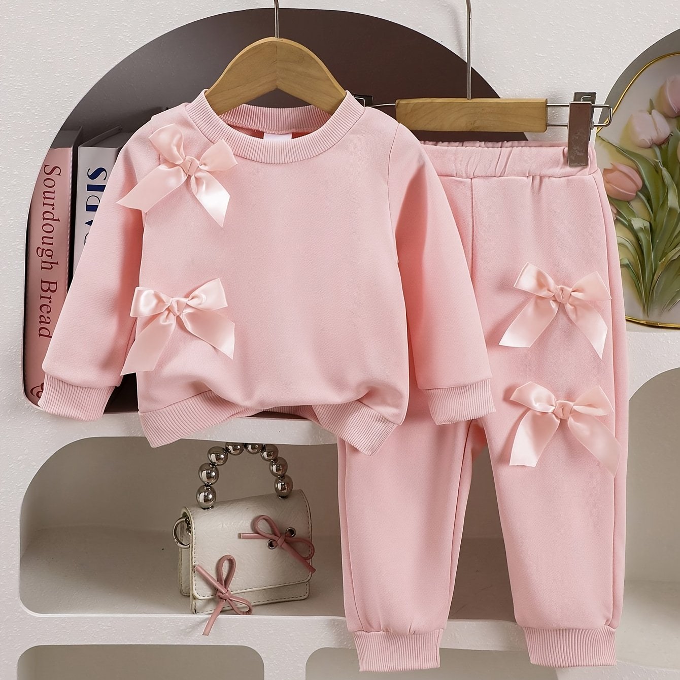 Baby girls' pink sweatshirt and pants set with double bows, ideal for outdoor wear in spring and autumn.