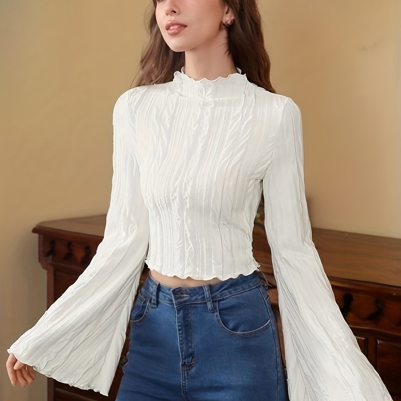 Textured cropped top with flared sleeves and lettuce trim mock neck, ideal for spring and fall.