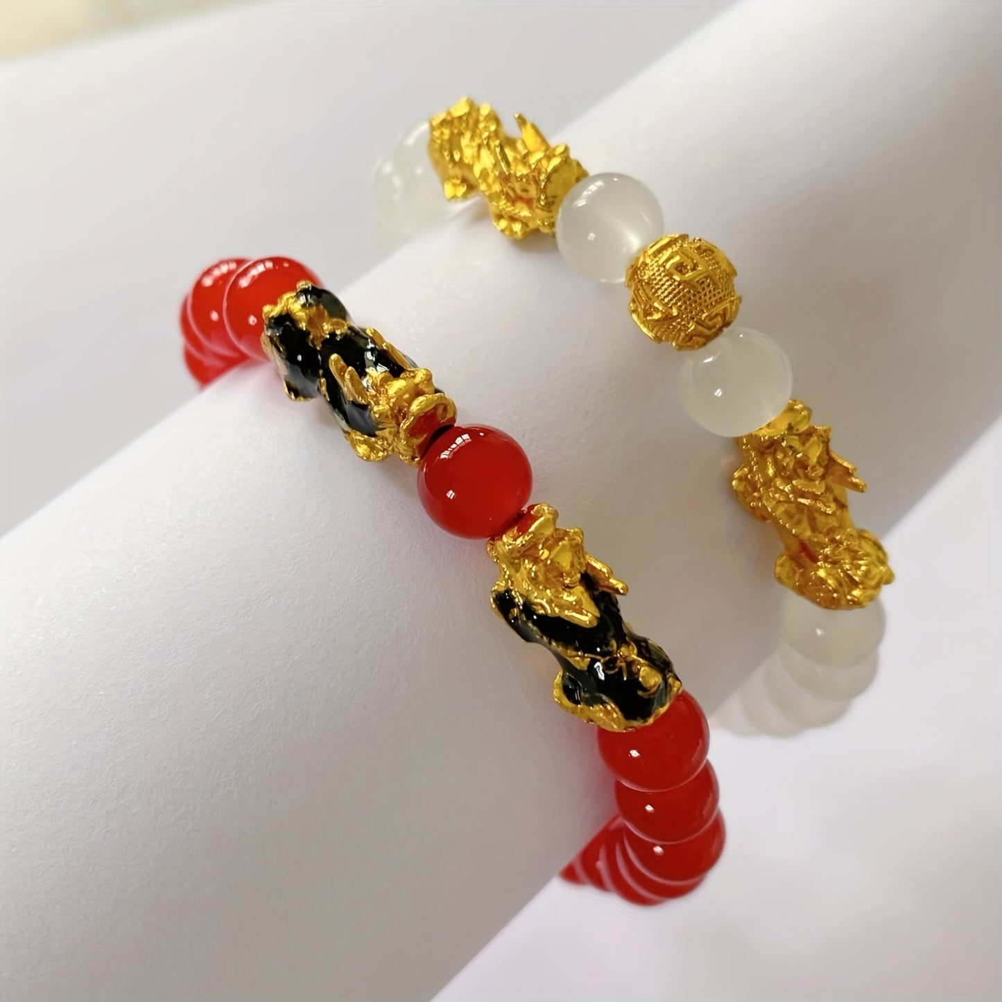 Two Pixiu bracelets, one in red antique style, offering a safe and lucky accessory. This classic, luxurious piece symbolizes prosperity and is beautifully crafted with shiny, artificial jewels. Perfect for gifting to girlfriends, sisters, or mothers to