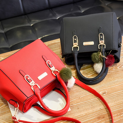 Stylish black handbag with golden-tone hardware and random ball charm, can be used as a versatile shoulder or crossbody bag for women. Ideal for travel, casual outings, and gift giving.