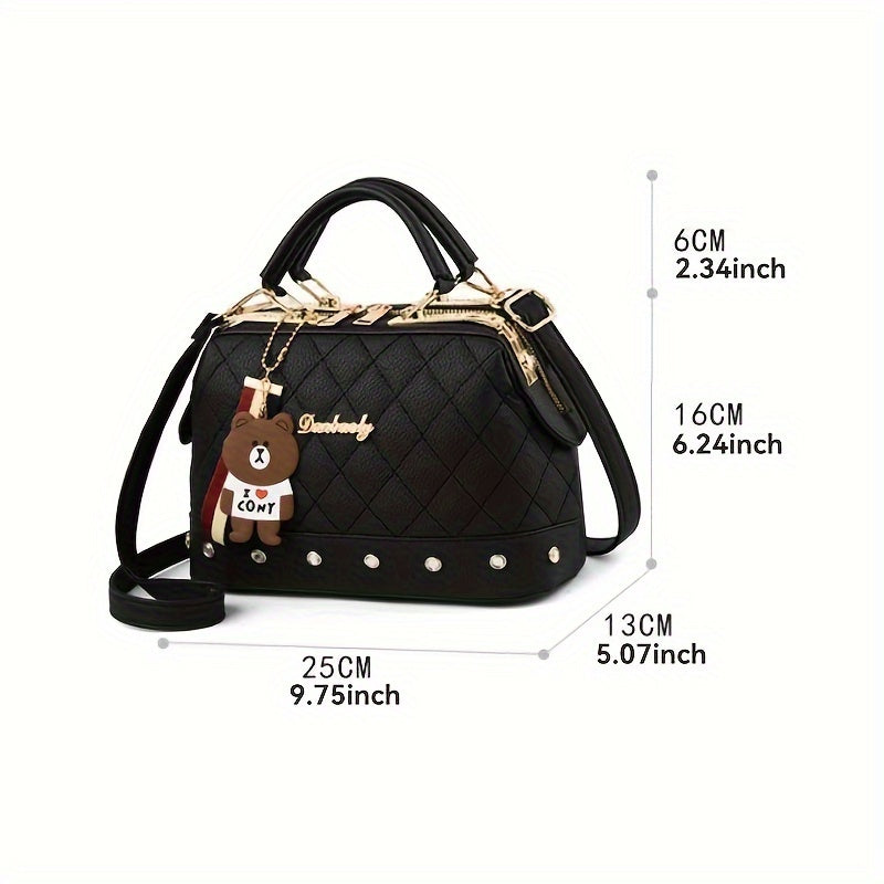 Stylish black shoulder bag for women with cute bear charm, detachable strap, zip closure, and quilted texture - ideal for travel and shopping.