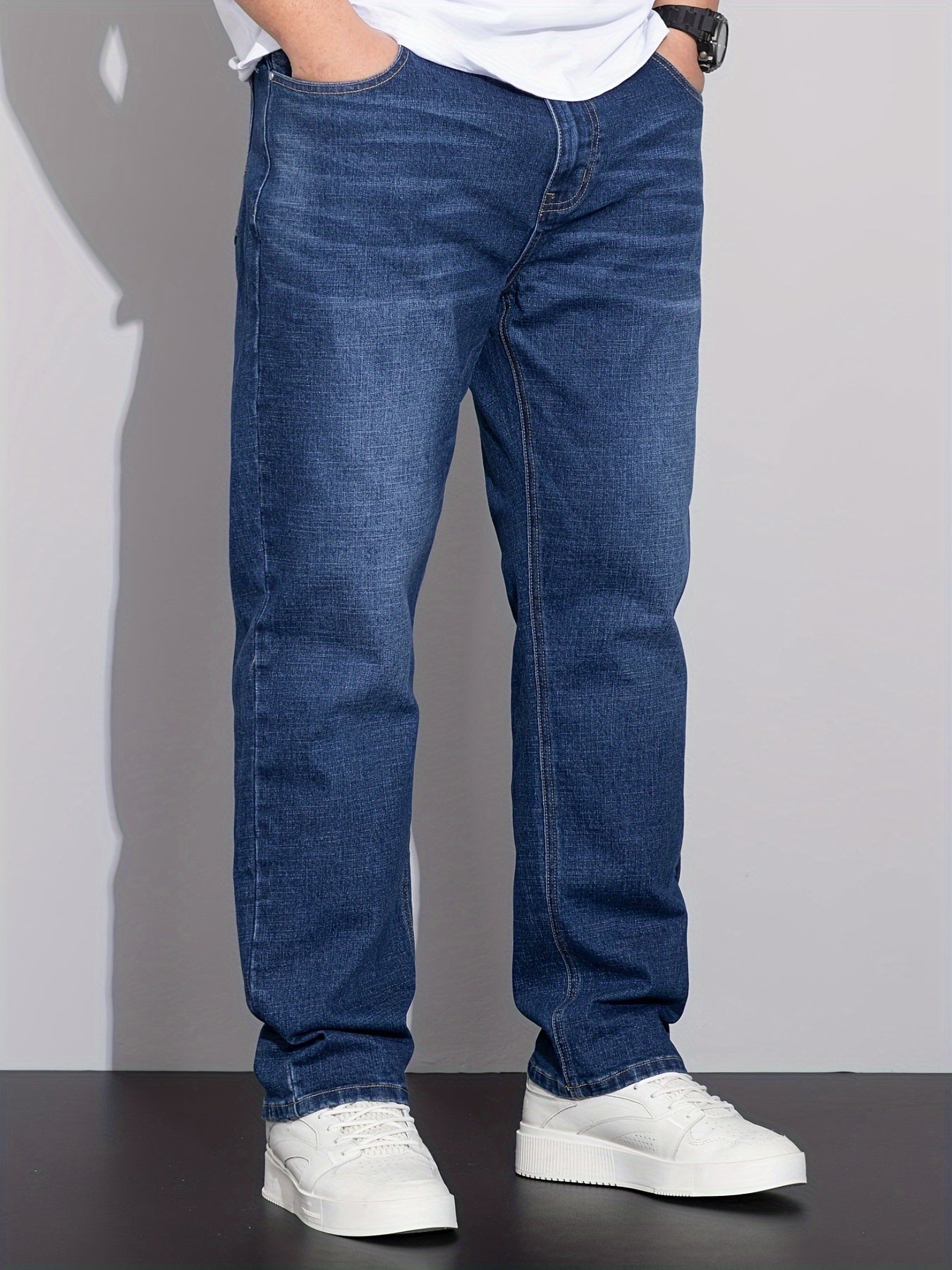 Men's stretchy cotton denim pants for all seasons, in a loose fit and plus size, perfect for business casual wear.